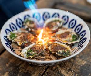 Oysters being fire roasted