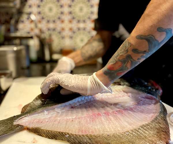 Chef butchering fish